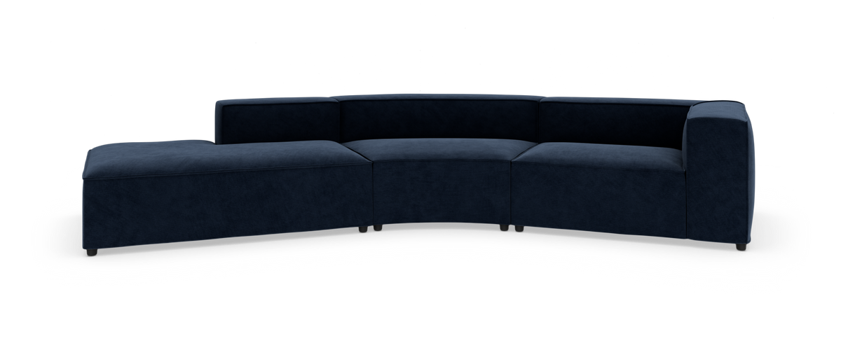 Mørkeblå modulsofa i buet sektion med venstre chaiselong, frilagt mod hvid baggrund.