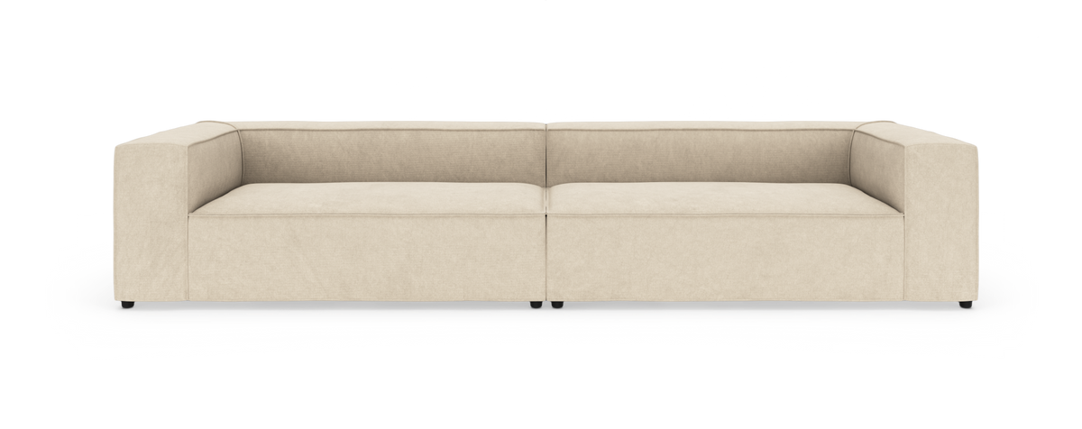 Beige, moderne modulsofa med lav ryg, set forfra mod hvid baggrund.