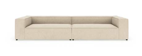 Beige, moderne modulsofa med lav ryg, set forfra mod hvid baggrund.