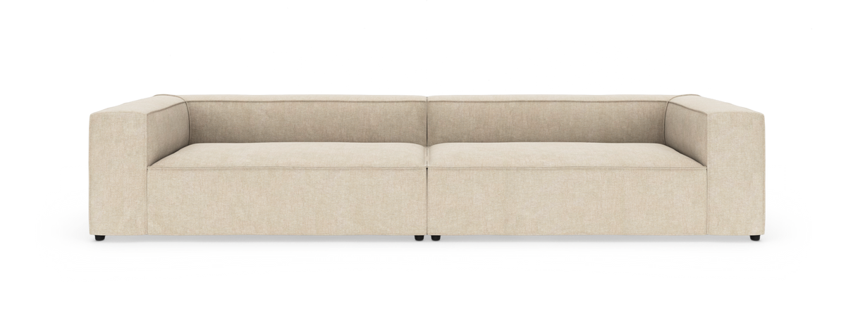 Beige modulsofa med brede, kantede armlæn, fotograferet forfra på hvid baggrund.