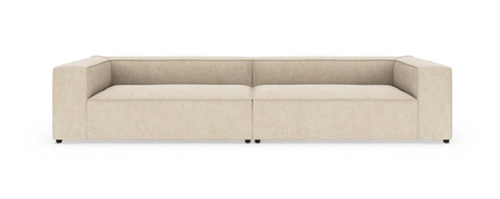 Beige modulsofa med brede, kantede armlæn, fotograferet forfra på hvid baggrund.