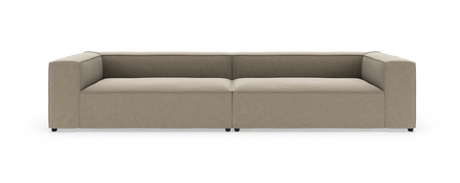 Beige modulsofa med lave ryglæn og brede armlæn, vist lige forfra på hvid baggrund.