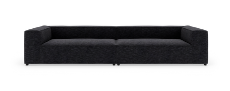 Lav, moderne sofa i mørkegråt stof på hvid studiobaggrund.