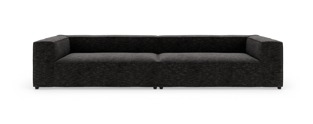 Mørkegrå moderne lav modulsofa med lige armlæn, fotograferet forfra mod hvid baggrund.