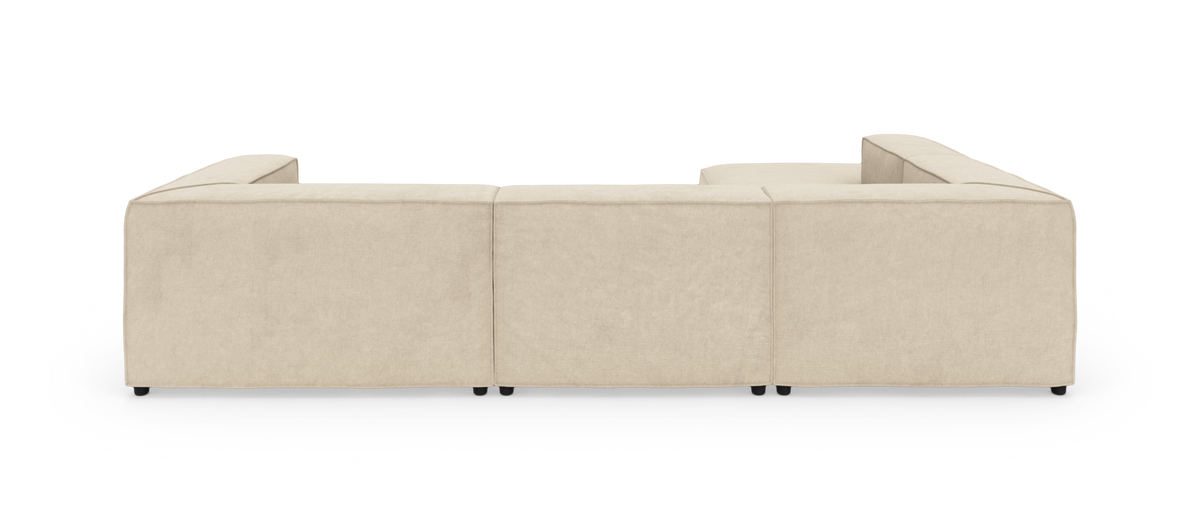 Beige modulsofa i U‑form set bagfra på hvid studiobaggrund.