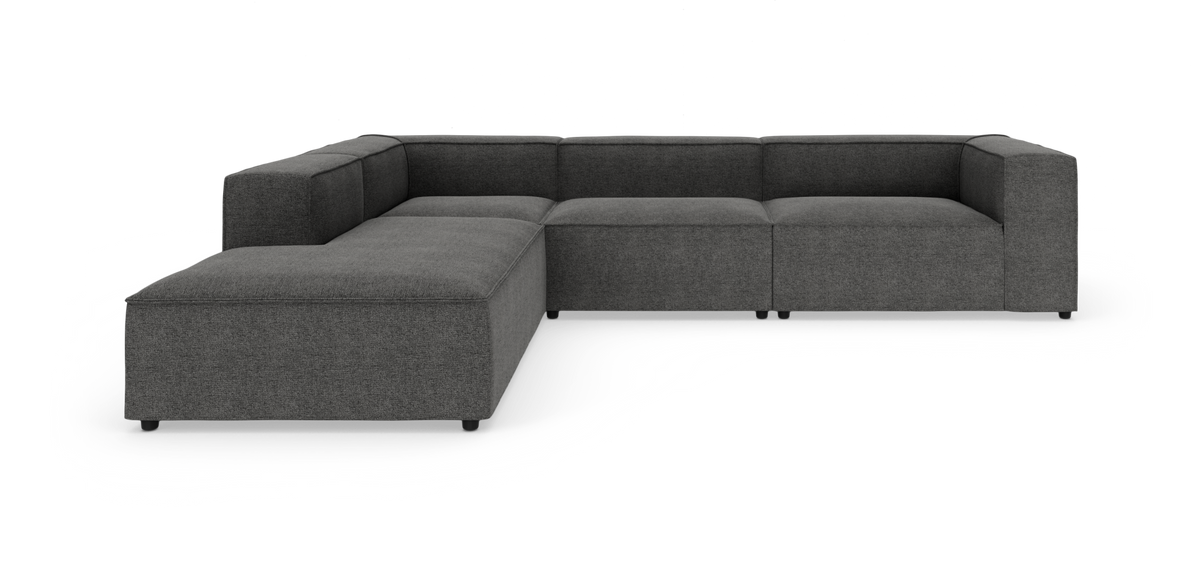 Mørkegrå modulær L‑sofa med venstre chaiselong på hvid baggrund.