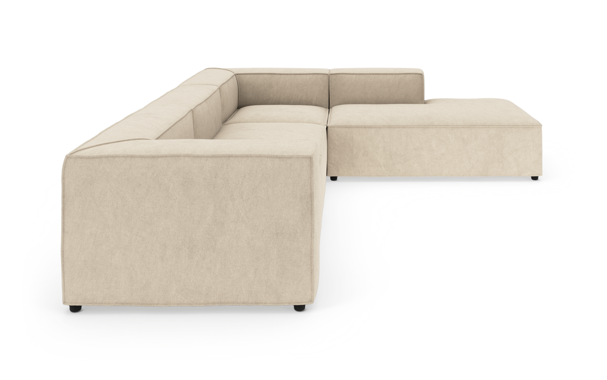 Beige modulsofa i L-form på hvid baggrund, vist i skrå forfra vinkel.