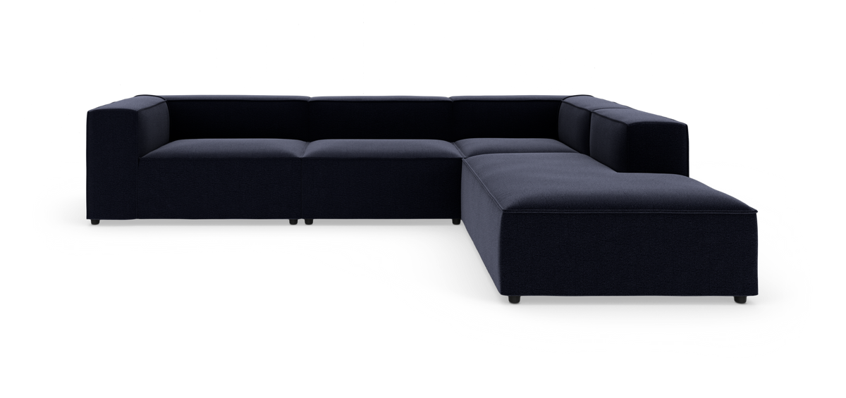 Modulsofa i mørkeblåt stof i L-form på hvid baggrund.