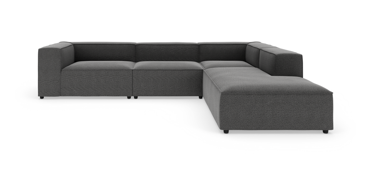Mørkegrå modulsofa i L‑form på hvid baggrund.