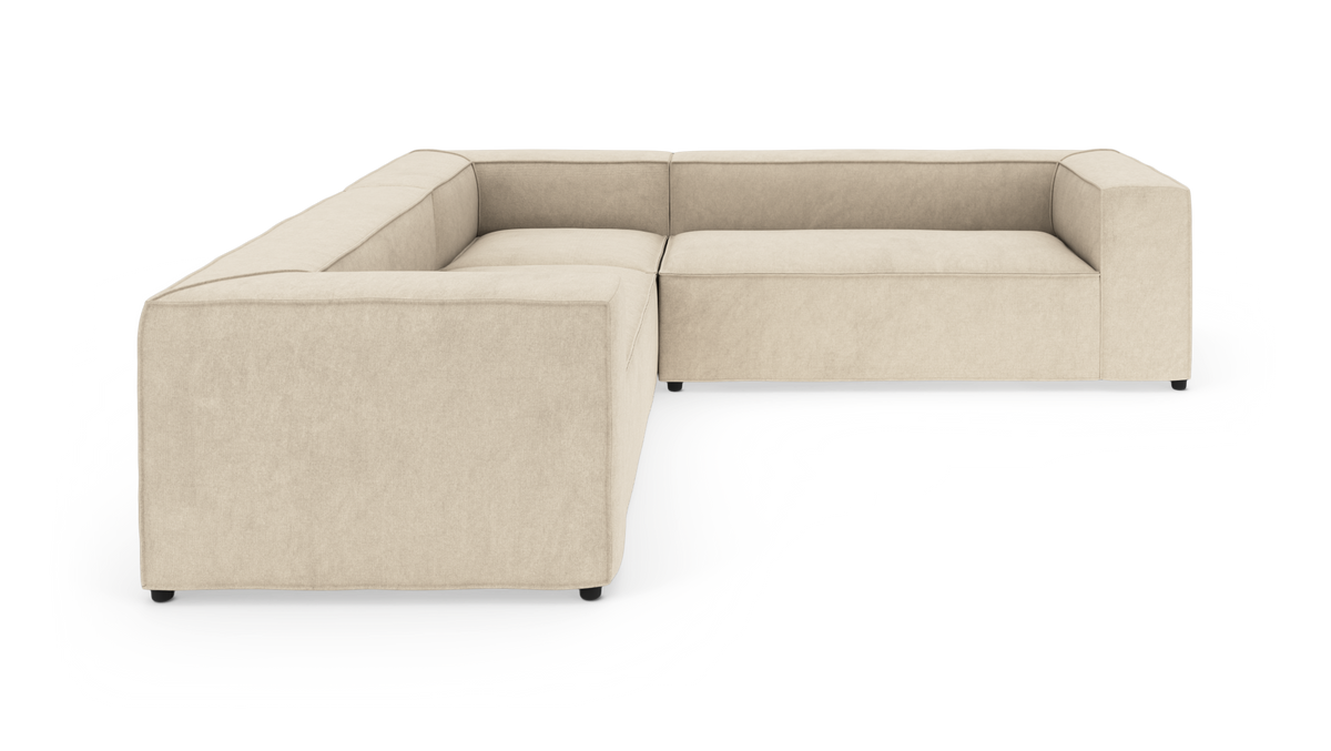 Beige L-formet modulsofa med lave rygge, vist på hvid baggrund.