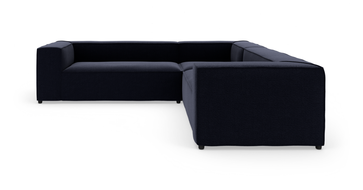 Mørkeblå modulsofa i U‑form på hvid baggrund.