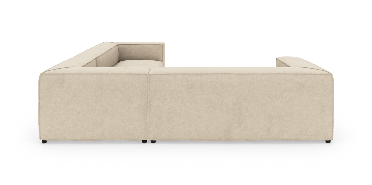 Beige U-formet modulsofa set bagfra på hvid studiebaggrund.