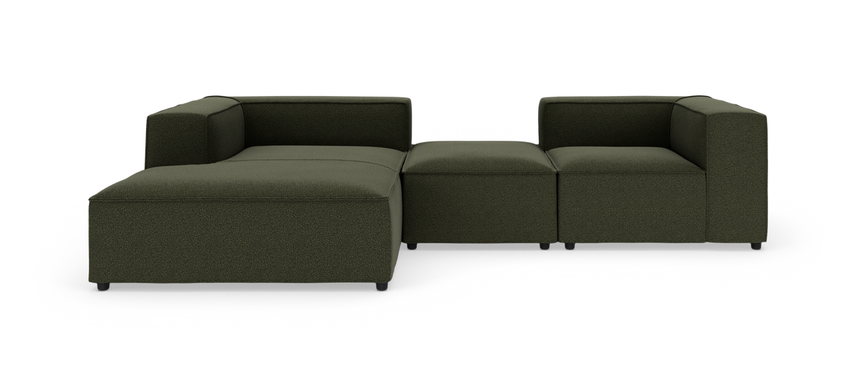 Modulær mørkegrøn hjørnesofa med chaiselong på venstre side, fritstående mod hvid baggrund.