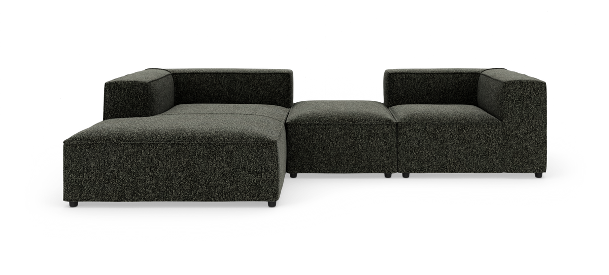 Modulsofa i mørkegråt stof med chaiselong og midterpuf, fotograferet lige forfra på hvid studiebaggrund.