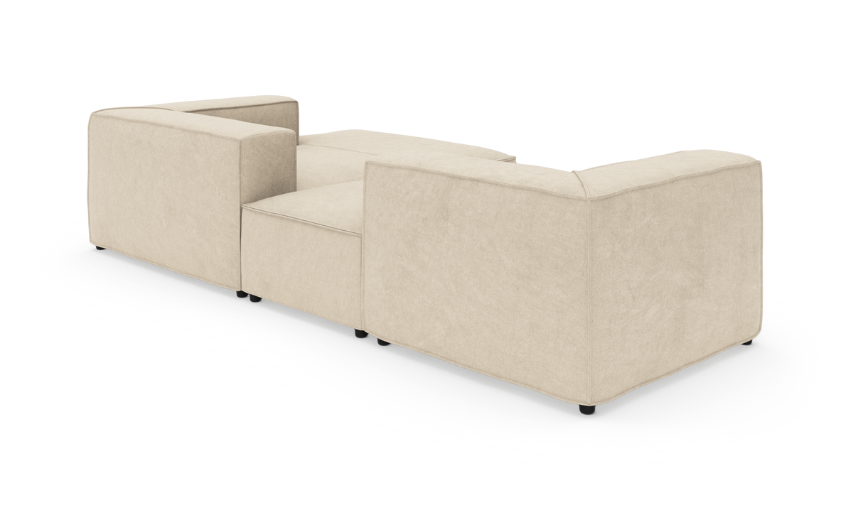 Beige L-formet modulsofa set bagfra i studie på hvid baggrund.