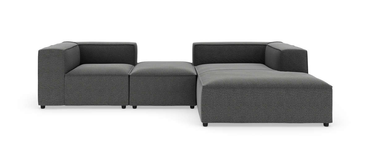 Modulær mørkegrå hjørnesofa i stof på hvid baggrund.