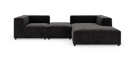 Modulær mørkegrå hjørnesofa i stof med bred chaiselong på højre side.