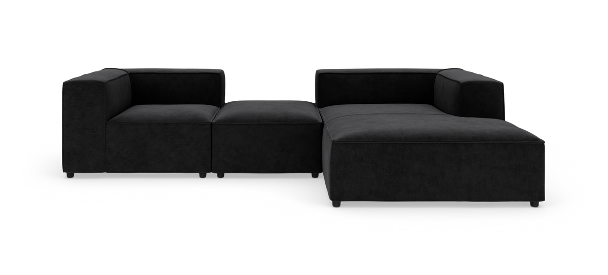 Modulær sort hjørnesofa med chaiselong og midtermodul, frilagt på hvid baggrund.