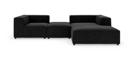 Modulær sort hjørnesofa med chaiselong og midtermodul, frilagt på hvid baggrund.