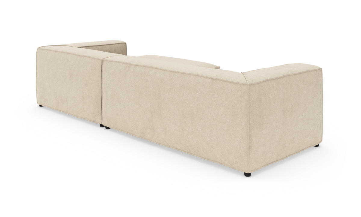 Beige modulsofa i U‑form set bagfra på hvid baggrund.