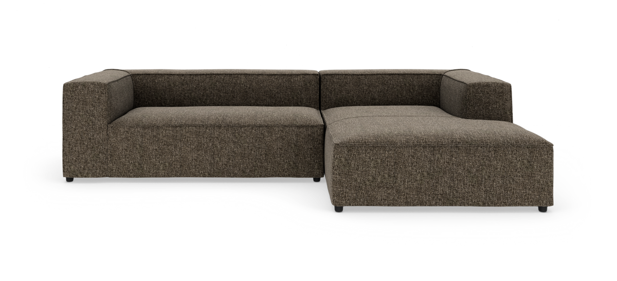 Modulsofa i L-form i brunmeleret stof på hvid baggrund.