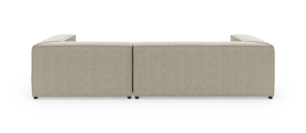 Beige modulsofa i stof set direkte bagfra, to sektioner side om side.