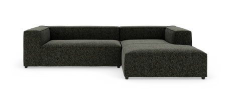 Mørkegrå modulsofa med chaiselong til højre, fotograferet mod hvid studiobaggrund.