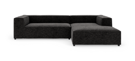 Mørkegrå modulsofa i L‑form med chaiselong til højre, frilagt på hvid baggrund.