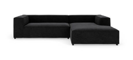 Sort modulsofa med chaiselong fotograferet i studie på hvid baggrund.
