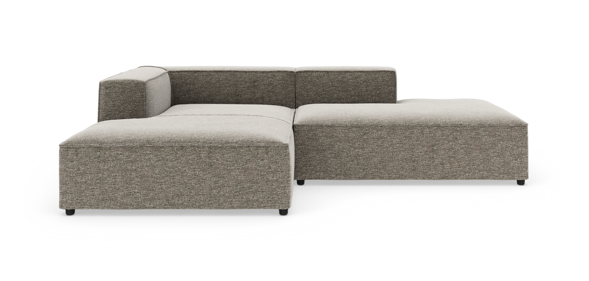 Modulær L-formet hjørnesofa i grå‑beige stof på hvid studiebaggrund.