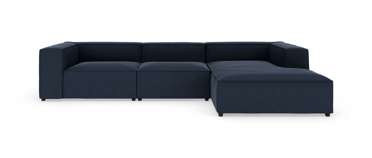 Modulær mørkeblå hjørnesofa med chaiselong til højre, frilagt på hvid baggrund.