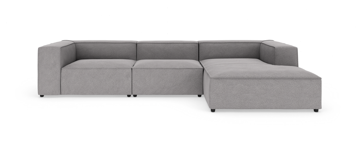 L-formet modulsofa i gråt stof, moderne design på hvid studiobaggrund.