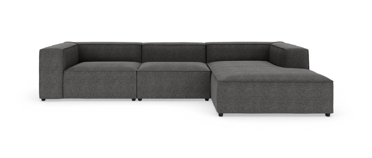 Mørkegrå modulær L-formet hjørnesofa med bred chaiselong på højre side.