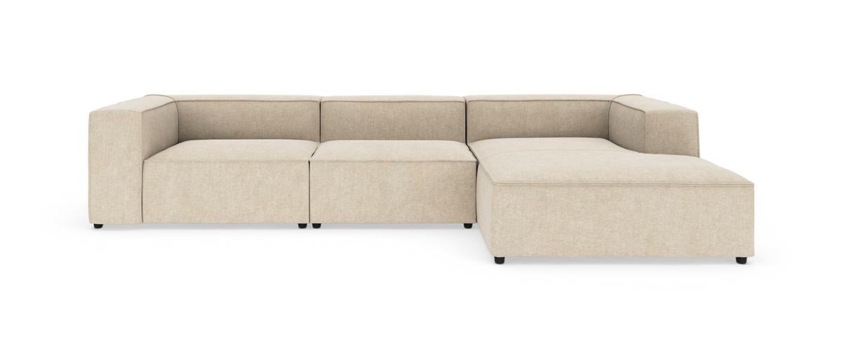 Beige modulsofa i L‑form på hvid baggrund.