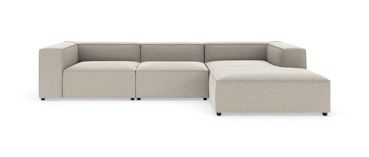 Beige modulsofa i L-form på hvid baggrund.