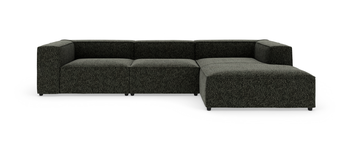 Mørkegrå modulsofa i L‑form på hvid baggrund.