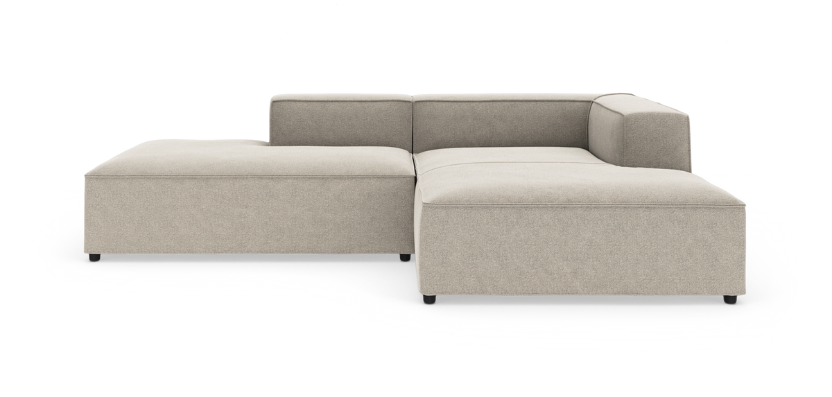 Modulsofa i lys beige stof med lav ryg og højrehjørne, frilagt på hvid baggrund.