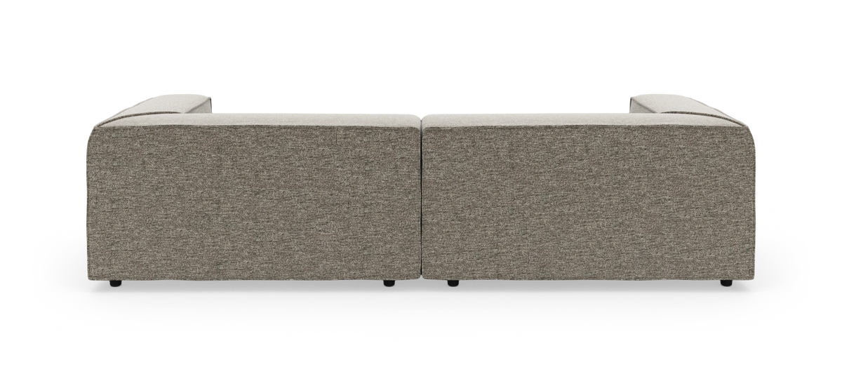 Modulær hjørnesofa i to sektioner set bagfra, polstret i grå‑beige stof på hvid studiobaggrund.