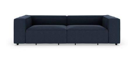 Mørkeblå, moderne modulsofa med brede lave armlæn set lige forfra på hvid baggrund.
