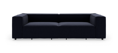 Mørkeblå, moderne modulsofa med brede armlæn set forfra mod hvid studiobaggrund.