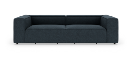Mørkeblå, lav modulsofa i moderne, boxet design frilagt på hvid baggrund, set lige forfra.