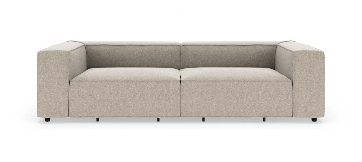Beige, moderne modulsofa med brede armlæn, frilagt mod hvid baggrund.