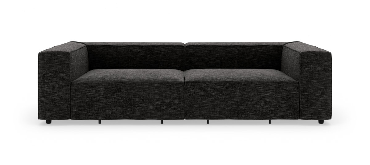 Mørkegrå, boxet stofsofa frilagt på hvid baggrund.