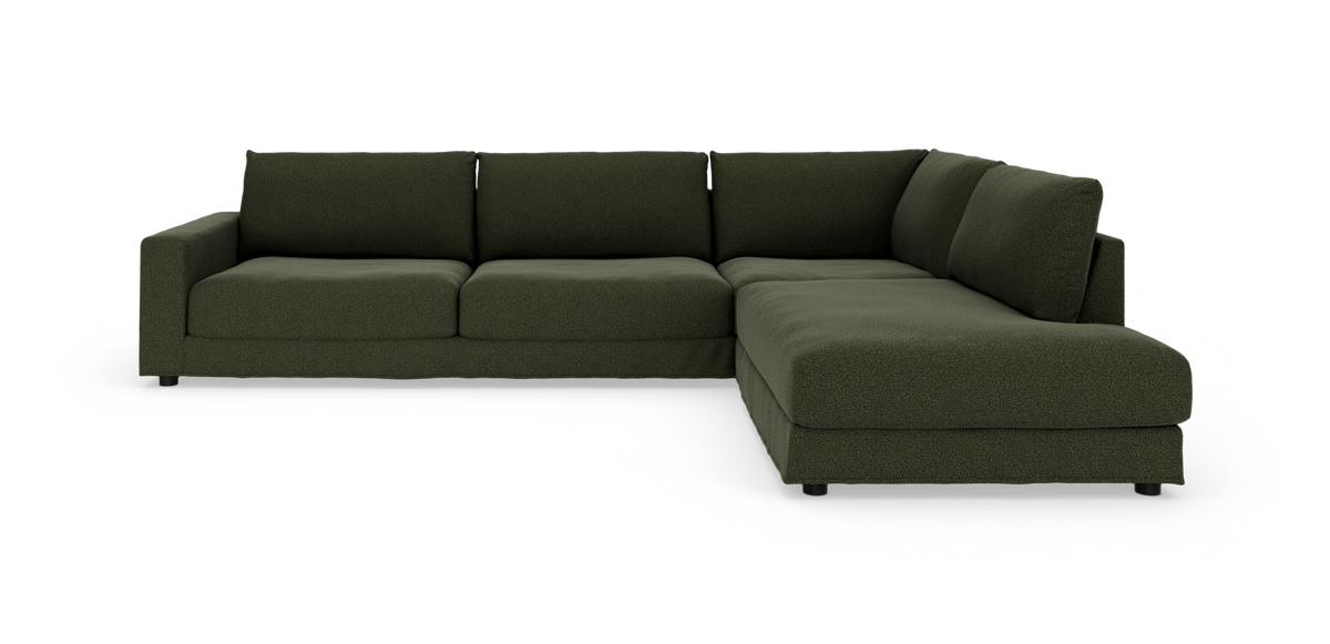 Mørkegrøn L‑formet modulsofa på hvid baggrund.