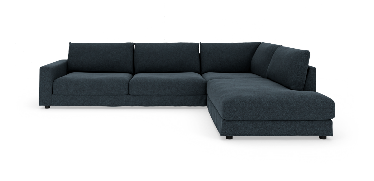 Mørkeblå L‑sofa med chaiselong til højre, fritstående på hvid baggrund.