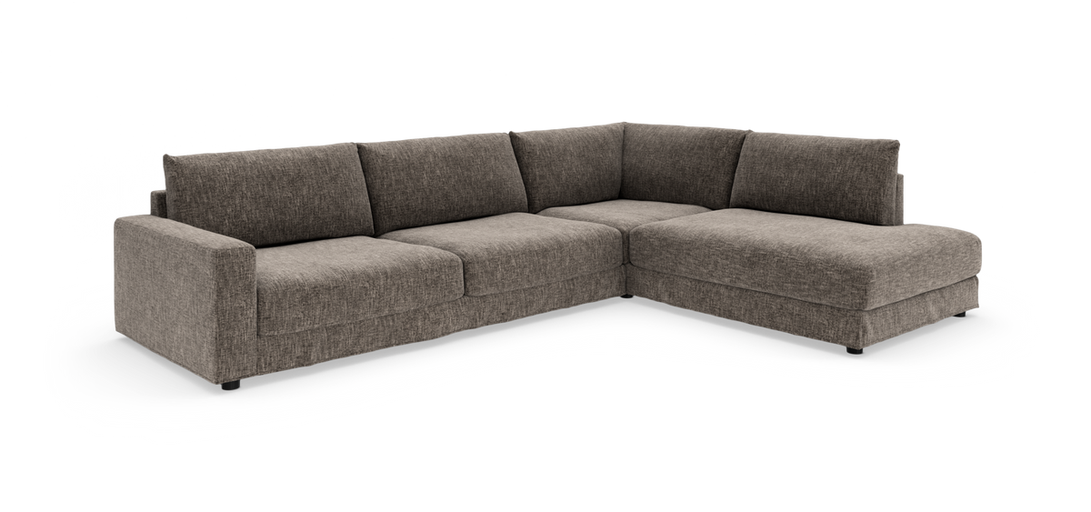 Hjørnesofa i gråmeleret stof med chaiselong til højre.