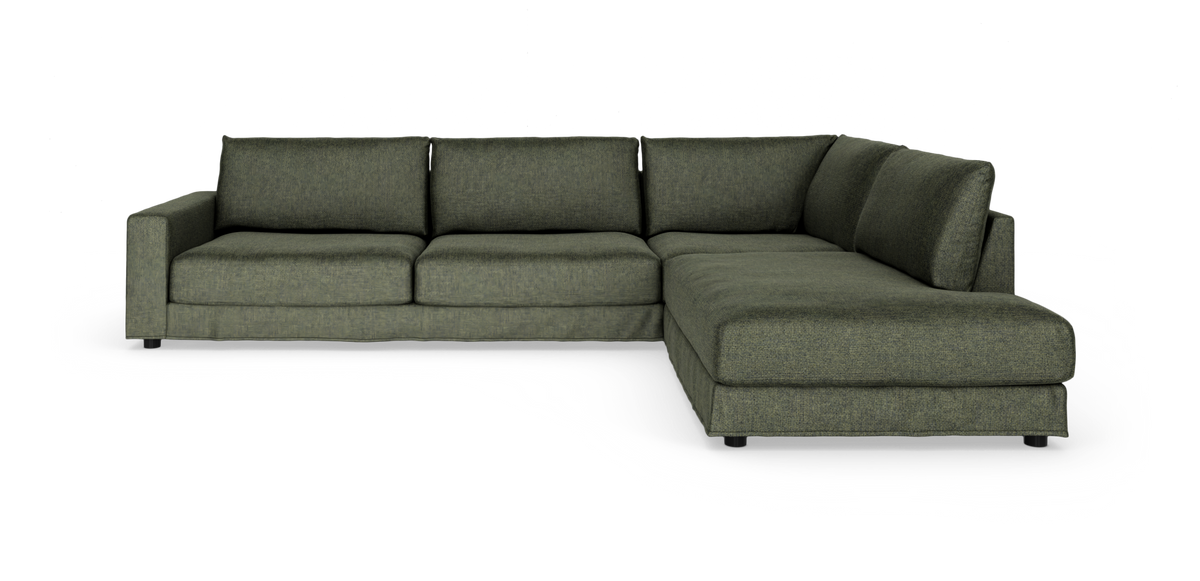 Grøn L-formet modulsofa med chaiselong til højre, fritstående på hvid baggrund.