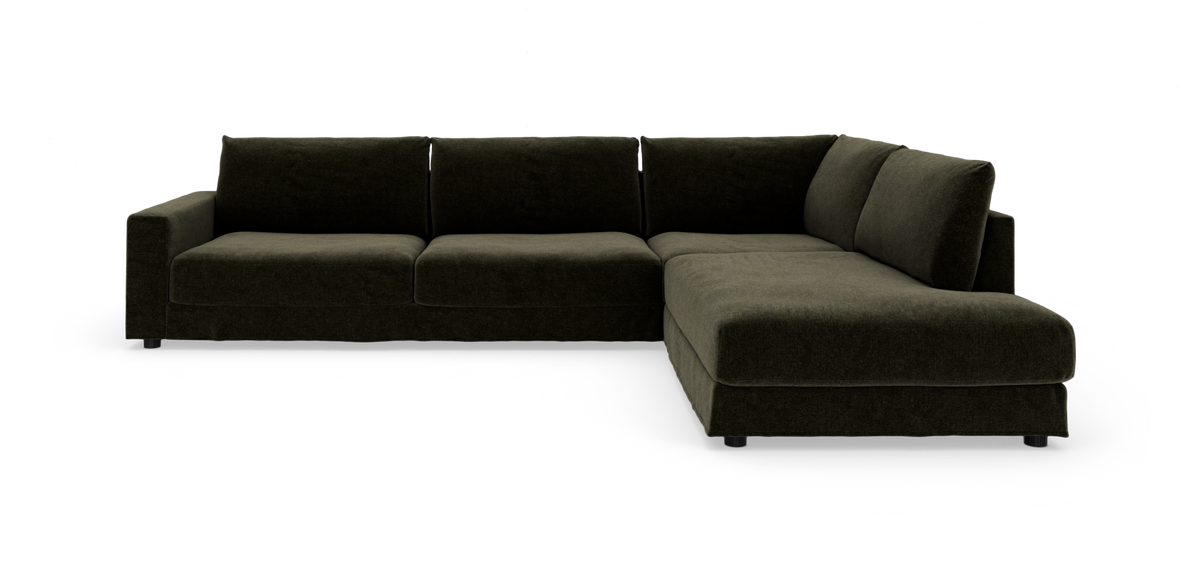 Mørkegrøn L‑formet modulsofa med chaiselong til højre, frilagt på hvid baggrund.