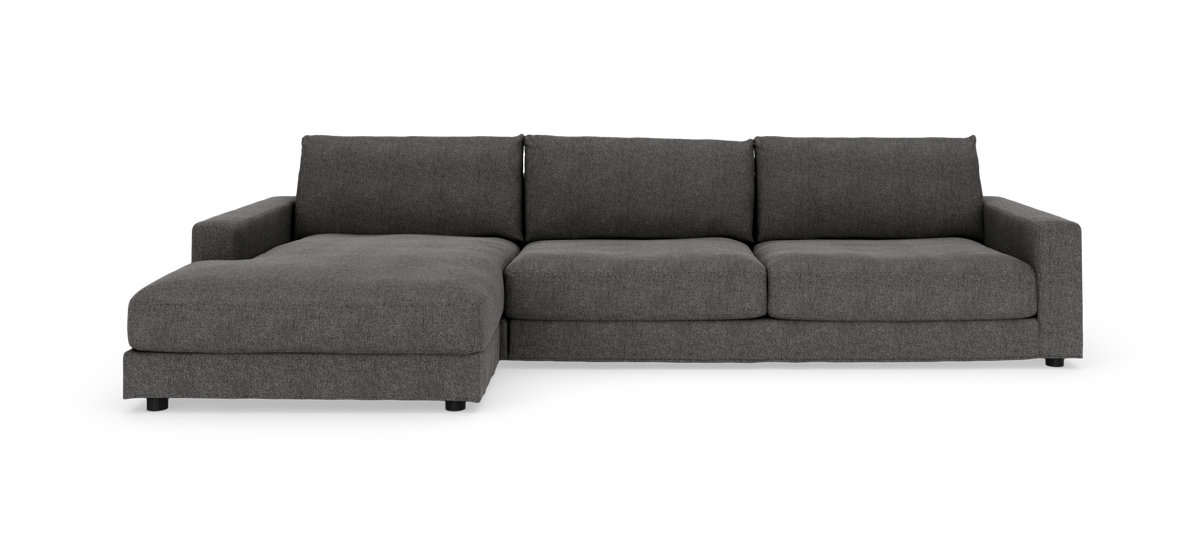 Mørkegrå modulsofa i L‑form med venstrevendt chaiselong og tre ryghynder, moderne design.