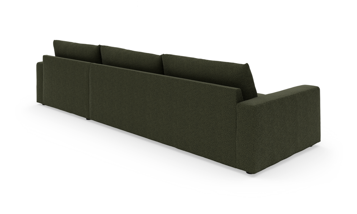 Mørkegrøn modulsofa set bagfra i studiemiljø.